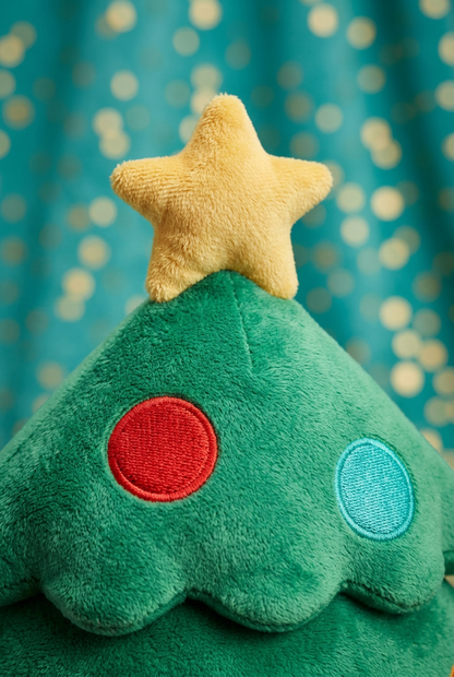 Yellow star and red and turquoise ornament details on the upper plush tree tier